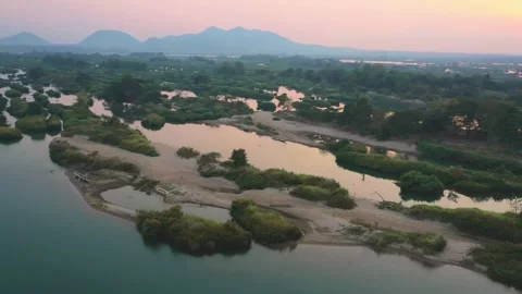 Orbiting aerial view of islets near Don Det, Laos. Dynamic drone shot at sunset Stock Footage 248214348