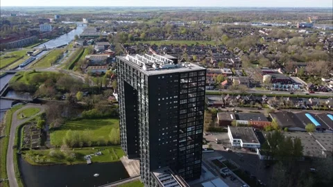 Orbiting aerial view of Tasman Tower, a modern apartment complex in Groningen. Video stock 181236443