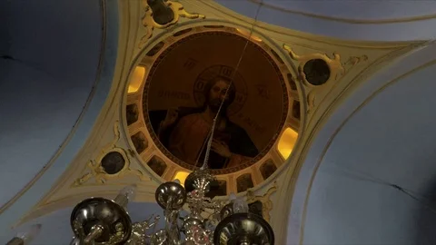 Orbiting around beautiful décor looking up at ceiling painting of Jesus. Stock Footage 116455185