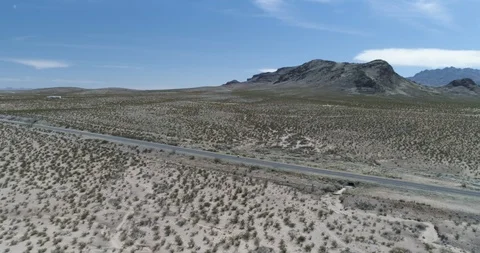Orbiting around cyclist  in huge desolate desert drone aerial 4K Stock Footage 111314467