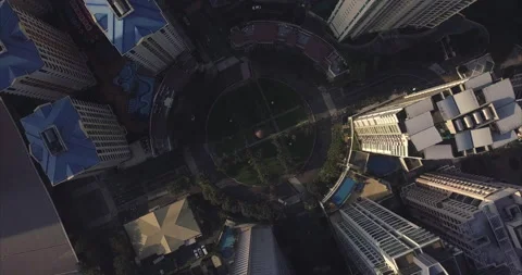 Orbiting ascending aerial flight over roundabout intersection in urban area. Vídeo Stock 130188650