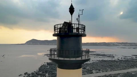 Orbiting Camera View of Udo Island behind a Lighthouse, Udo-biyangdo, Jeju. Stock Footage 146067180