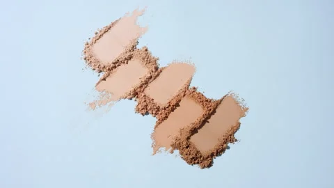 Orbiting capture of beige to brown powder on blue background Stock Footage 337125965