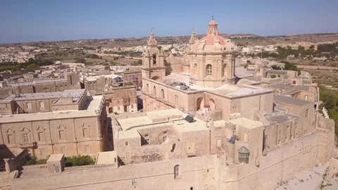 Orbiting counter clockwise around back of St. Paul's Cathedral in Mdina Malta Stock Footage