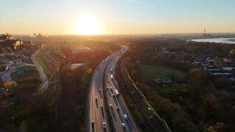 Orbiting drone move linking A42 traffic and steel plant Stock Footage 331190093