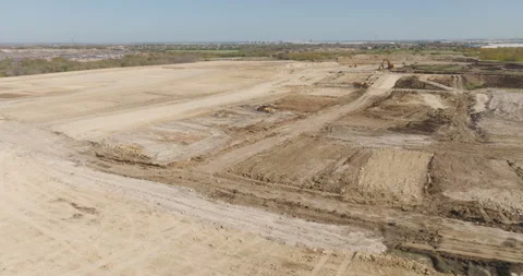 Orbiting Drone Shot of Construction Site with Bulldozer, Dump Trucks &amp; Excavator Stock Footage 301668710
