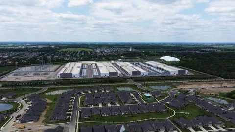 Orbiting Drone Shot Large Data Center next to Suburban Residential Video stock 346197810