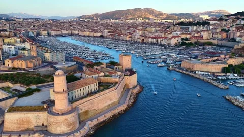 Orbiting drone shot of Marseille old port, France, flying over historic fort and 스톡 동영상 313272323