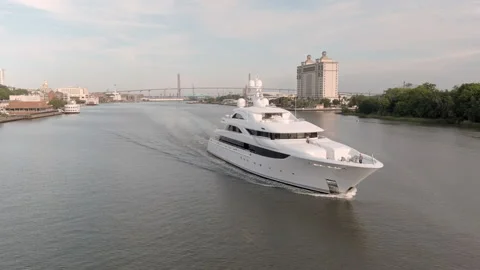 Orbiting drone shot of mega yacht motoring out of port. Stock Footage 154554731