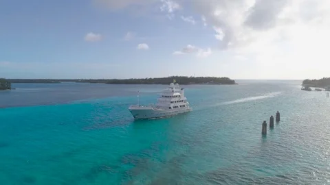 Orbiting Drone Shot of a Yacht Pulling into a Marina in Bimini 4K Stock Footage 84239346