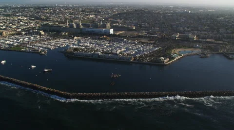 Orbiting left to right above harbor and jetty at Redondo Beach, California. Shot Stock Footage 59112697