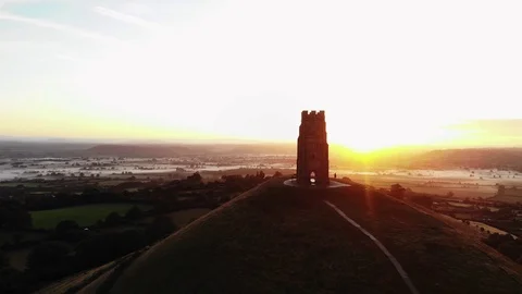 Orbiting the misty sunrise over Glastonbury Tor and the Somerset levels. Stock Footage