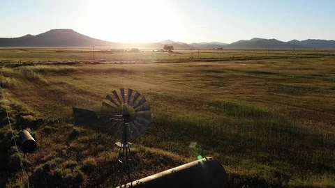 Orbiting Old Farm Windmill in Field - Aerial Drone Stock Footage 114110215