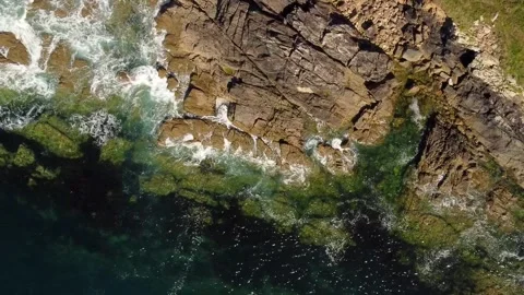 Orbiting Over Rocky Sea Edge With Crashing Waves. Aerial Topdown Vídeos de archivo 243299774