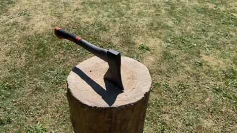 Orbiting shot of axe embedded in wooden chopping block, 4k, slow motion Stock Footage 312524172