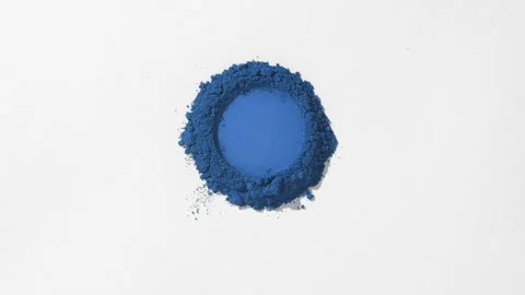Orbiting shot of blue powder on subtle grey surface Stock Footage 340501306