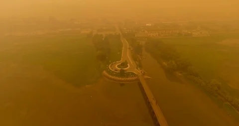 Orbiting shot of pier and roundabout in smoke cause by BC wildfires Stock Footage 94151264