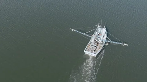Orbiting shot of shrimp boat pulling nets in the ocean Stock Footage 167078955