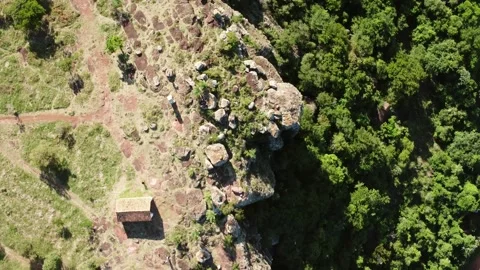 Orbiting Top Down Aerial View of Rocky Cliff and Forest in Paraguari Видео 335906684