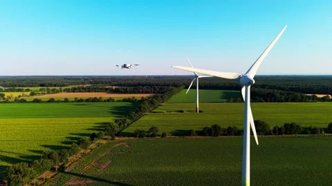 Orbiting wind turbines with drone in background Stock Footage 340920334