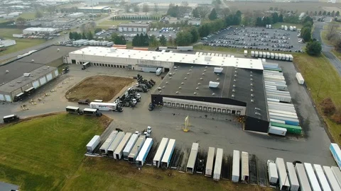 Orbitting aerial of distribution center with Amazon Prime, United Parcel Stock Footage 122432176