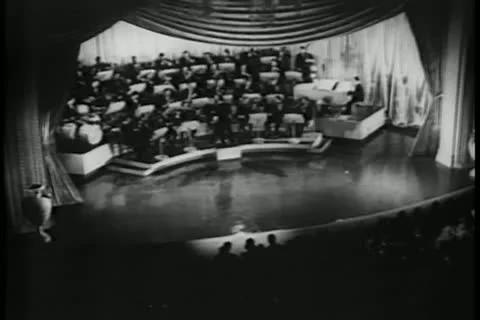 Orchestra and conductor on stage performing Stock Footage 11352380