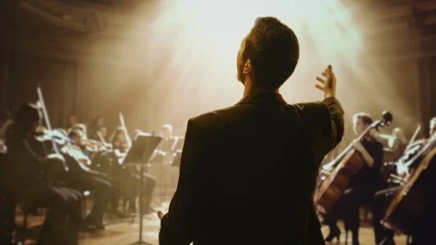 Orchestra Conductor Leading Symphony Performance Classical Music Stage Dramatic Stock Footage 291891200