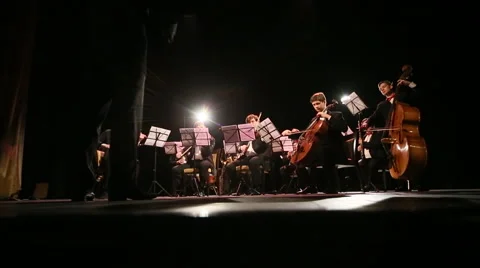 Orchestra with conductor plays on stage Video stock 45174340