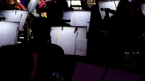 The orchestra's performance in dim light Stock Footage 83563338