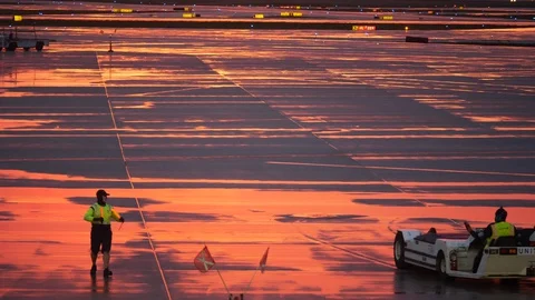 ORD ramp worker wears smiling face mask at sunset Stock Footage 129285830