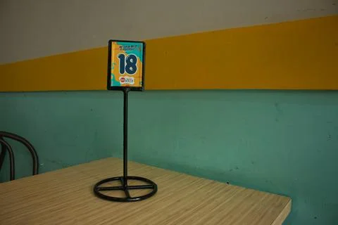 Order numbers standing on the table in the cafe. Stock Photos