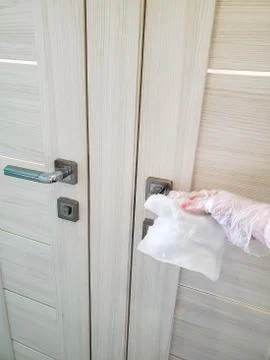 In order to prevent the spread of the virus and pandemic, wipe public door Stock Photos