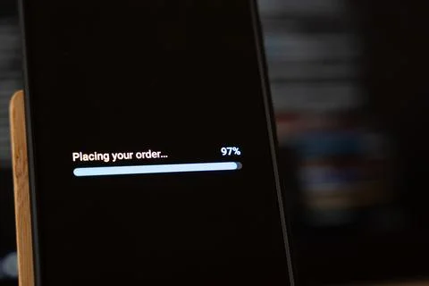Order processing almost complete at 97 percent on a smartphone progress bar with Stock Photos