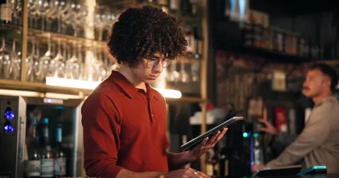 Order, reading and tablet with bartender in restaurant at night for hospitality 스톡 동영상 312721200
