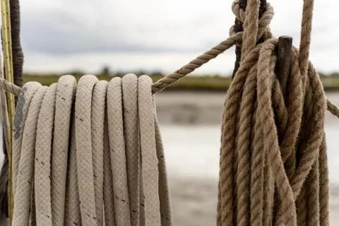 Ordered rope rigging of a boat tied up neatly in a loop Stock Photos