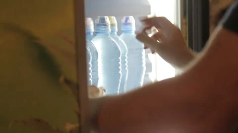 Ordering bottles in the refrigerator of supermarket Stock Footage 63215958