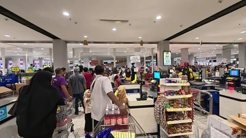 Orderly Queue at Hypermarket Payment Counter with Full Carts Video stock 321437415