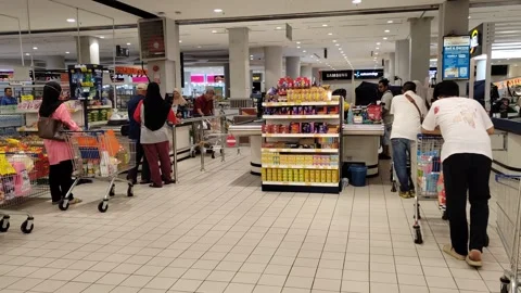 Orderly Queue at Hypermarket Payment Counter with Full Carts Stock Footage 321437418