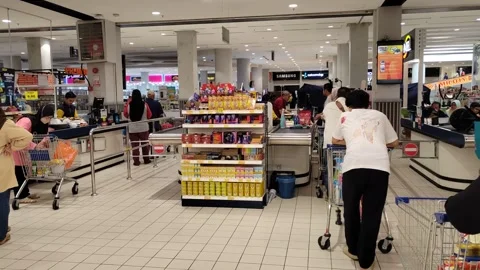 Orderly Queue at Hypermarket Payment Counter with Full Carts Stock Footage 321437480