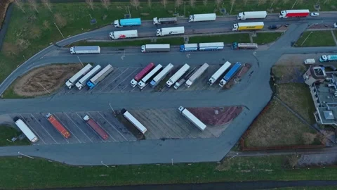 Orderly Trucks At Stop. Resting Fleet Of Vehicles Aligned Peacefully By Stock Footage 334042270