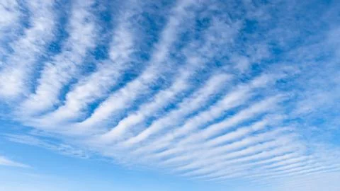 Orderly white clouds floating in the blue sky Stock Photos