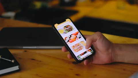 Orders food using online delivery Stock Footage 138042198