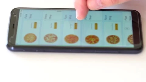 Orders Food Using Online Delivery. Pizza. The screen is blurred. Stockbeeldmateriaal 145664675