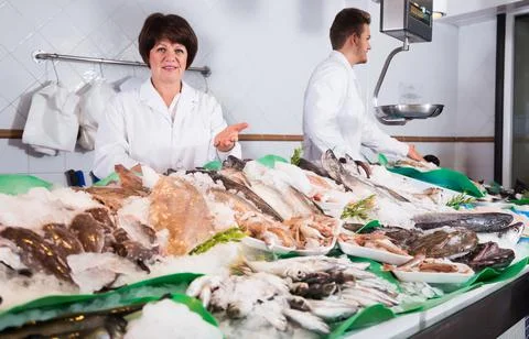 Ordinary fish store with two glad sellers Stock Photos