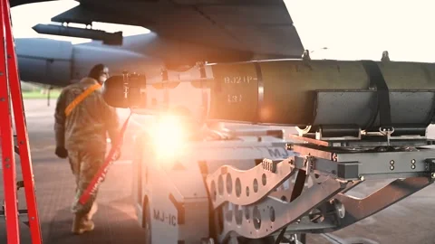 Ordnanceman loading GBU-38 JDAM onto B-52 Stratofortress using a bomb loader Stock Footage 293060636
