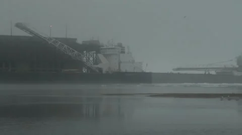 Ore boat docking behind another ore boat in the fog Stock Footage 40462394