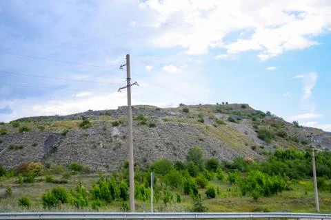 Ore slag dumps after processing. Old stepped terricon in form of a hill with  Stock Photos