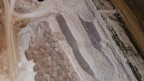 Ore storage. Excavator loads ore. Bird's eye view Video stock 73422167