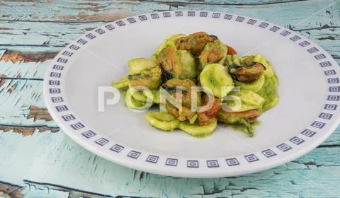 Orecchiette with broccoli cream and mussels Stock Photos