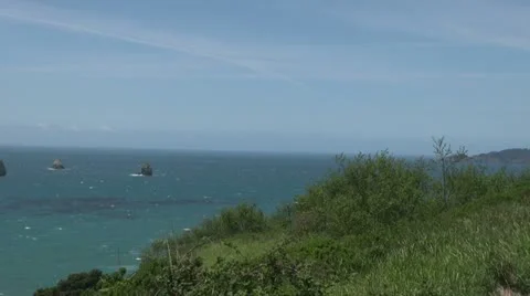 Oregon Coast with Wind Rocks with waves in distance 스톡 동영상 11275239